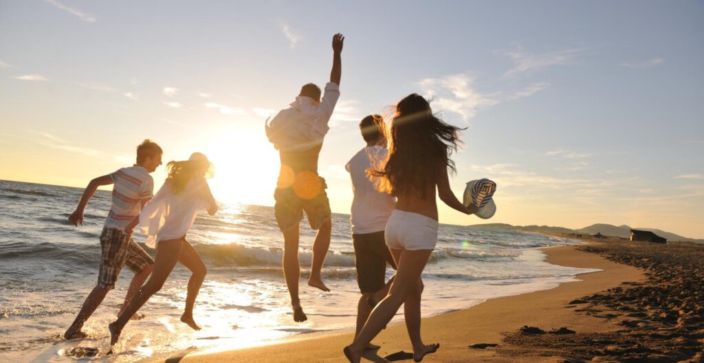 friends walking down a beach