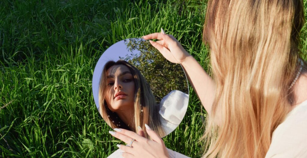 woman looking at herself in the mirror