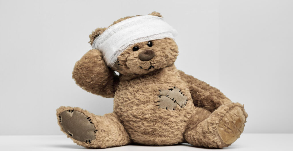 injured teddy bear with wounds around its head